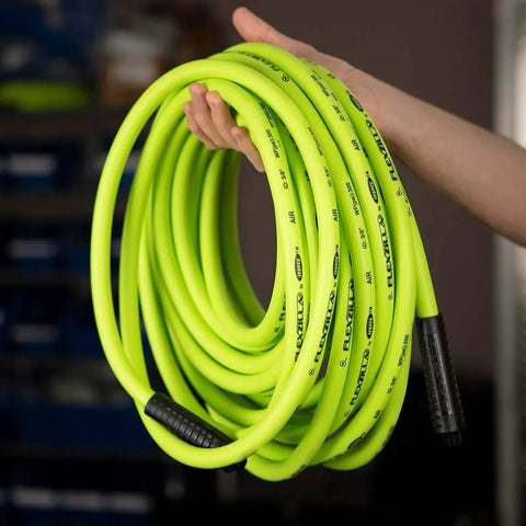 ZillaGreen Air Hose Three Eighth Inch By Fifty Feet With Quarter Inch MNPT Fittings shown coiled in hand