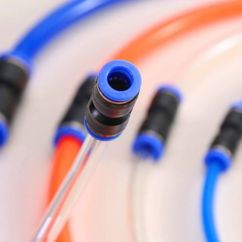 Blue push-to-connect pneumatic hose fitting on a clear tube; close-up with orange and blue hoses in the background