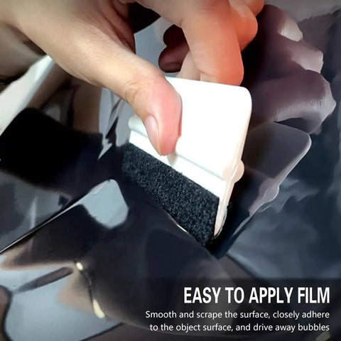 Hand using felt squeegee to apply film from All In One Car Window Tint Kit With 18 Piece Tool Set For Easy DIY Vinyl Wrap And Glass Protection