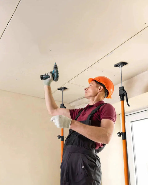 Worker using Adjustable Cabinet Jack Support Pole 49.2 To 114.2 Inches 154 LB Capacity 2 Pack to install ceiling.