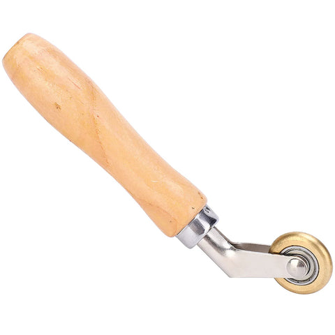 Wood-handle seam roller with brass wheel for wallpaper or membrane installation.