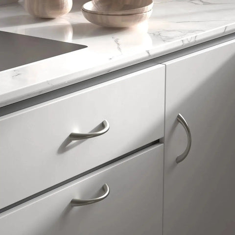 Curved Cabinet Handles Set of 10 Solid Zinc Alloy Brushed Nickel Drawer Pulls 5 Inch Center to Center installed on white cabinets