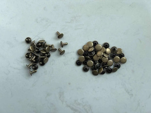 Copper Grounding Rivets For Shoes, Barefoot Earthing Accessories, Black Small shown in separate piles on a surface