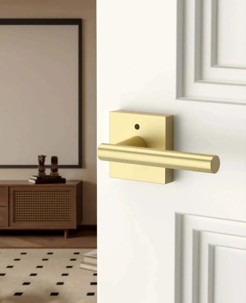 Gold Privacy Door Handle Set With Keyless Interior Button on white bedroom door, brushed gold modern lever and knob.