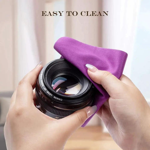 Person cleaning camera lens with purple microfiber cloth, showcasing use of Microfiber Cloths For Glasses And Screens Safe For Coated Lenses 6 Pack 5.7x6.7.