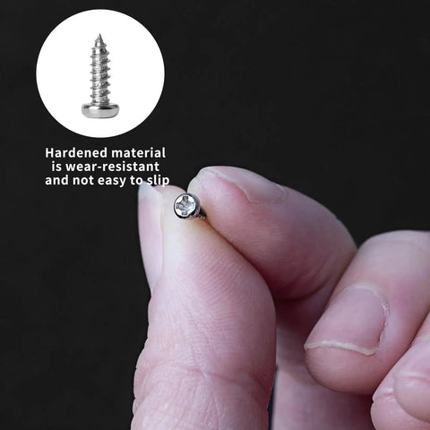 Close-up of hand holding tiny nickel-plated Phillips self-tapping screw from Ultra Handy 1200-Piece Mini Screw Kit for glasses and electronics.