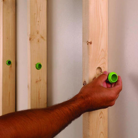 EZ Guard single stud electrical wire protector, green cap being installed on a wooden stud; 5-pack by Amazon