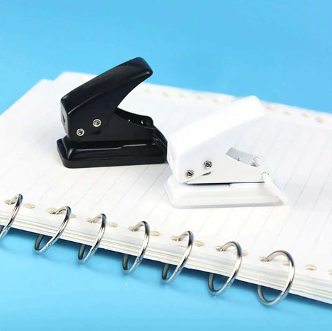 Two Pack Small Black And White One Quarter Inch Circle Hole Punch Handheld Tool for Paper and Leather Craft on notebook