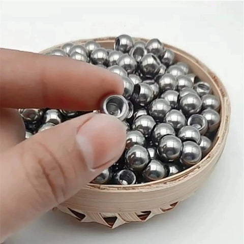 Close-up of Stainless Steel Piercing Replacement Balls M6 Threaded Half Hole 10 12 Mm in a bamboo basket.
