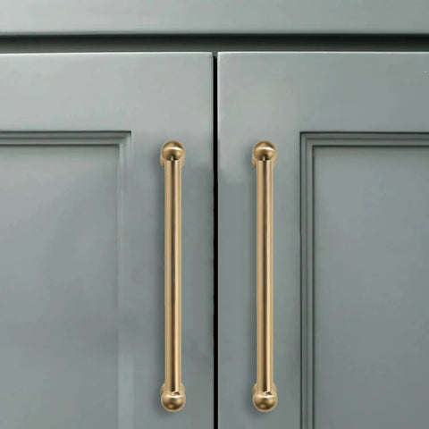 10 Pack 3-Inch Solid Zinc Alloy Cabinet Handles Brushed Gold Finish With Satin Brass Accents installed on grey cupboards