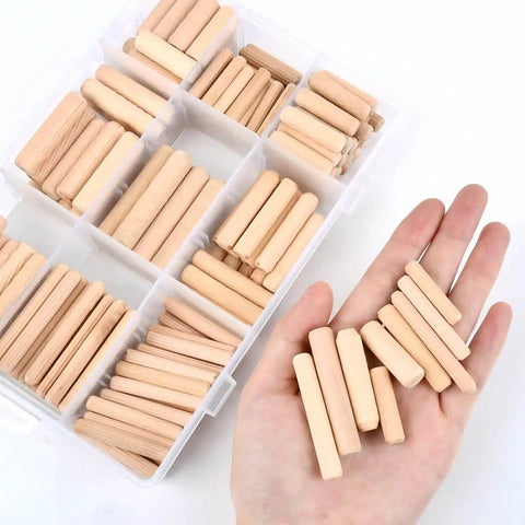 Hand holding assortment of wooden dowel pins from a box, part of Wooden Dowel Pins Set, 200 Pcs, Nine Sizes With Tapered Beveled Ends and Fluted Grooves.