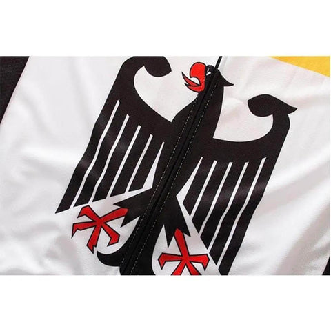 Close-up of a zipper on a garment with a black and red stylized eagle graphic design on a white background.