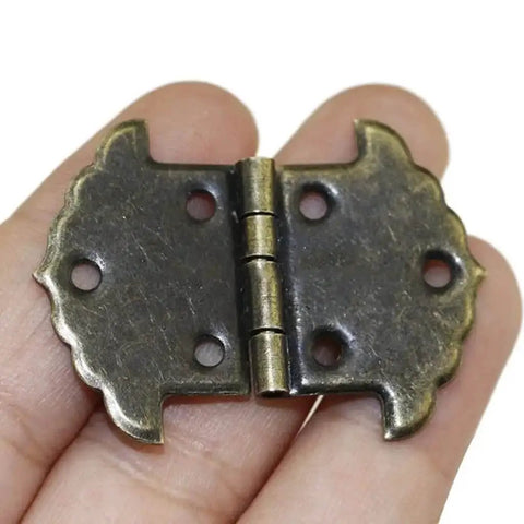Lace Iron Hinge For Cabinets And Furniture, heavy duty metal hinge with square link buckle, held in hand, green bronze finish
