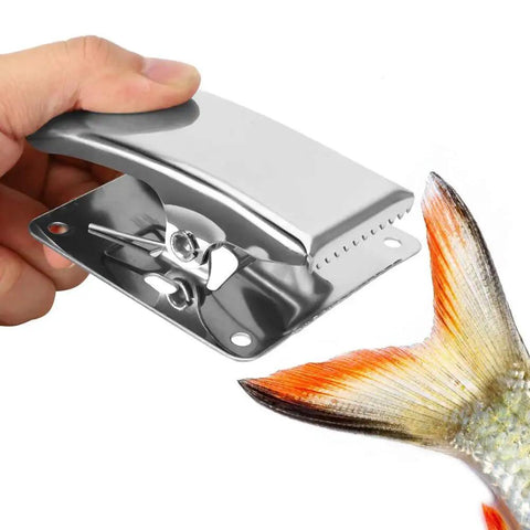 Hand holding stainless steel clamp gripping fish tail for precision; part of Six Piece Fish Fillet Clamps Set In Stainless Steel With Built In Spring Deep Claw Tail Grips To Prevent Slips During Cleaning And Filleting Pro Grade Utility For Outdoor Camping Picnics And Home Kitchen Use Making Prep Easy And Precise.