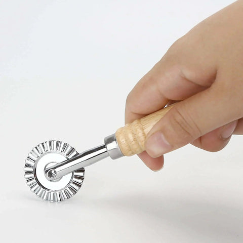 Hand using 2 Piece Zinc Alloy Crinkle Cutter Set With Long Wooden Handle For Pizza Wheel And Ravioli Press Perfect For Making Pasta Noodles