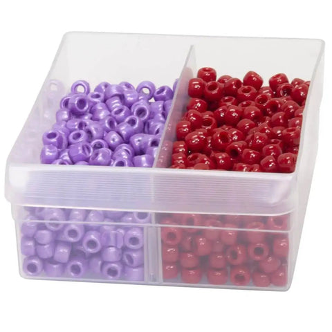 Plastic storage box with clear dividers separating purple and red beads.