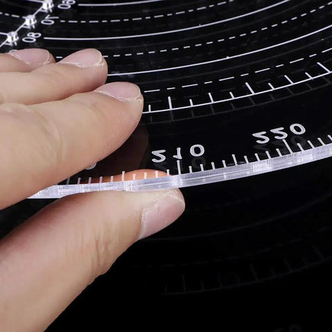 Close-up of Round Center Finder Compass for Wood Turners Lathe Work, clear acrylic with 5mm increment circles, 300mm diameter.