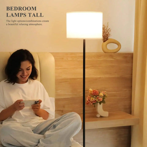 60 Inch Black Floor Lamp With White Shade And Foot Pedal Switch For Living Room beside seated person