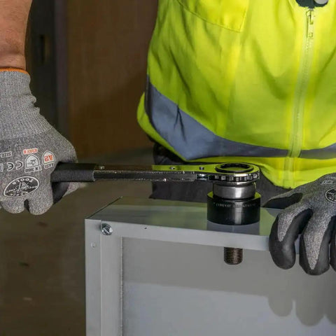 Optimized Design 10 Gauge Mild Steel Knockout Punch Set With Black Finish in use to puncture electrical panel