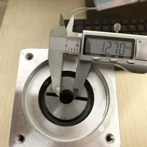 Close-up of 3 To 1 Planetary Gearbox For Nema 34 Stepper Motors with caliper measuring one half inch input shaft diameter.