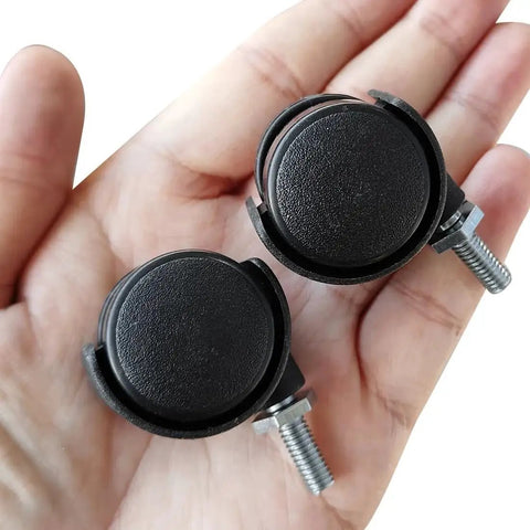 Hand holding two 1.2 Inch Nylon Wheel Caster With M6 Threaded Stem Non Brake Swivel, showing black wheels and silver stems.