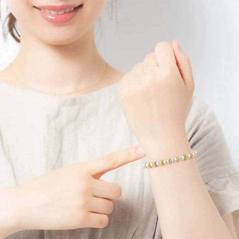 Woman wearing bracelet made with 800 Pcs 6mm Flower Spacer Beads Multicolor Daisy Flower Metal Alloy Spacers For DIY Jewelry Making