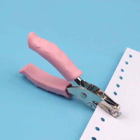 Handy Metal Handled Paper Punch With 6mm Circle Hole, 6.3 Inch Length, Rubber Grip, shown punching paper on blue background
