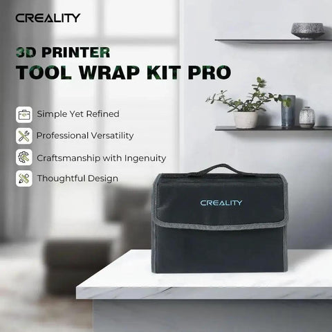 Creality 3D Printer Tool Wrap Kit Pro in black, resting on white desk with green plant on shelf in background
