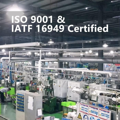 Automobile production facility with ISO 9001 and IATF 16949 certification signage.