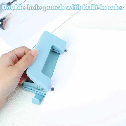 Person using a blue Two Hole Paper Punch Metal Blue Desktop Puncher For File Folders And Loose Leaf Books Beefy Built To Last Heavy Duty