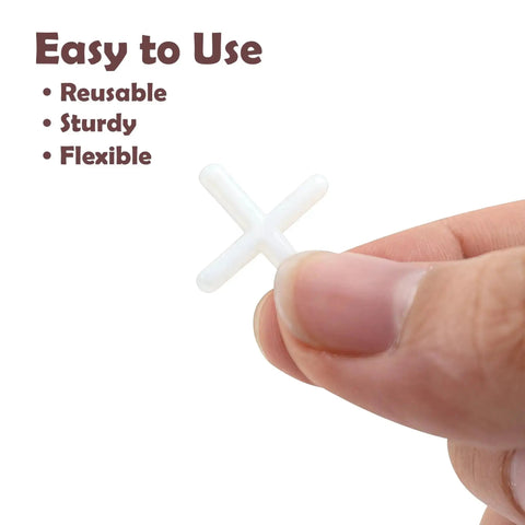 Hand holding 2mm cross tile spacer from 300 Pack for wall and floor tiling precise spacing durable plastic tile locator leveling slab spacers