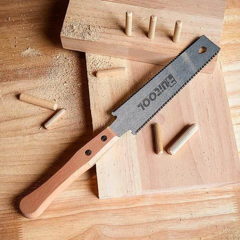 6 Inch Japanese Pull Saw Ryoba for Woodworking on wooden surface with dowels, double edge flexible SK5 blade, beech handle visible