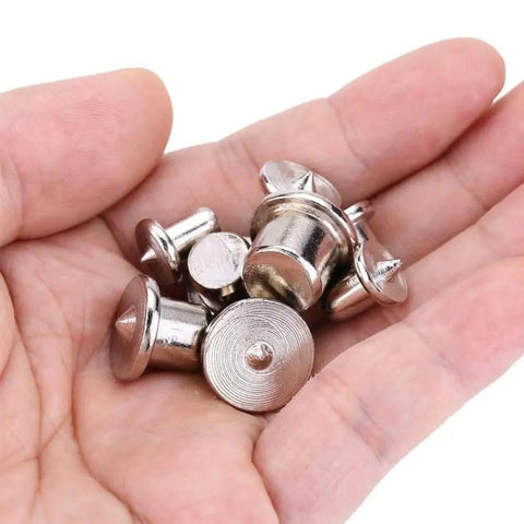 Hand holding 48 Piece Metal Dowel Center Pins Set For Pro Grade Woodworking With Four Sizes showing chromed finish and rust resistance.