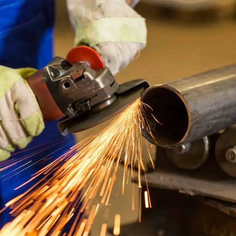Person using an angle grinder on metal pipe with sparks flying. Grinder Flange Wrench And Lock Nut Kit For 4.5 Inch To 5 Inch Grinders Visible