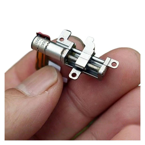 Close-up of 5mm Gearbox Stepper Motor, 8mm Stroke Linear Actuator for phone camera rigs, held between fingers for size reference.