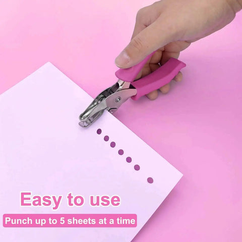 One Quarter Inch Hole Punch For Crafts With Pink Soft Grip Handle in use punching paper on pink background.