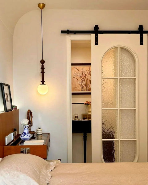 Oil Rubbed Bronze Sliding Barn Door Hardware Kit With 8 Foot Track In Brushed Antique Bronze Finish, installed in a bedroom