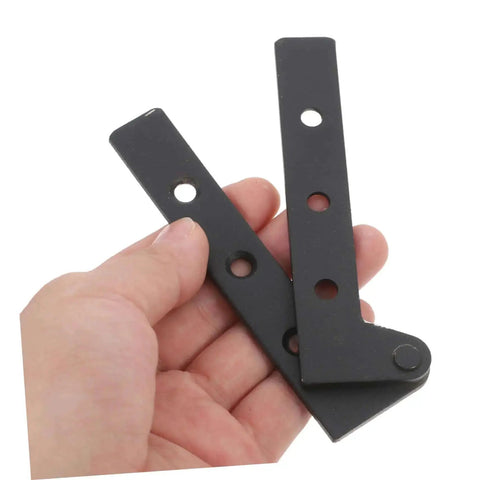 Hand holding two black metal pieces from Two Pack Heavy Duty Pivot Hinge Hidden Door Hardware For Secret Doors Easy Install Kit Built To Last Ideal For Cabinets And Home Use With Universal Compatibility And Sturdy Construction.