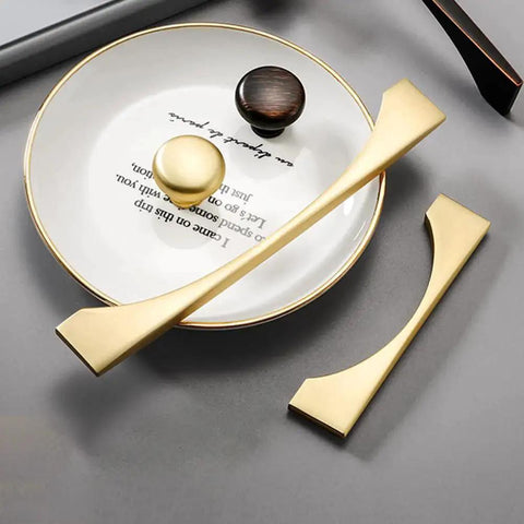 4 Pack Brushed Gold Cabinet Drawer Pulls in Zinc Alloy with Brushed Brass Finish, shown on a gray surface with circular decor.