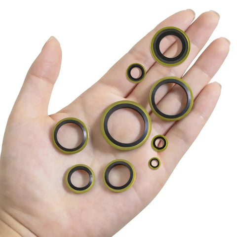 A hand holding assorted sizes of sealing washers from a 378 Piece NBR Metal Bonded Sealing Washer Kit With 12 Sizes M6 Through M30 For Automotive Self Centered Seal Gasket Repair Set, High Pressure And Heat Resistant Rubber To Metal Gaskets.
