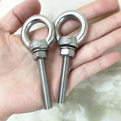 Close-up of 4 Pack M8 Stainless Steel Eye Bolts With Washers And Nuts, Beefy Heavy Duty Ring Eyebolts in hand, showing 2 inch thread length.
