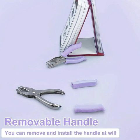 One Hole Puncher For Paper Crafts With Purple Soft Grip Handle next to books, showcasing removable handle feature