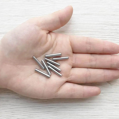 100 Pieces 3mm x 18mm Stainless Steel Dowel Pins For Shelf Support And Cabinet Fastening in a hand, rust resistant metal fasteners.