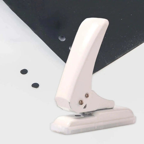 Portable Workhorse One Hole Punch Handheld Metal Hole Puncher With 40 Sheet Paper Capacity shown punching through black paper