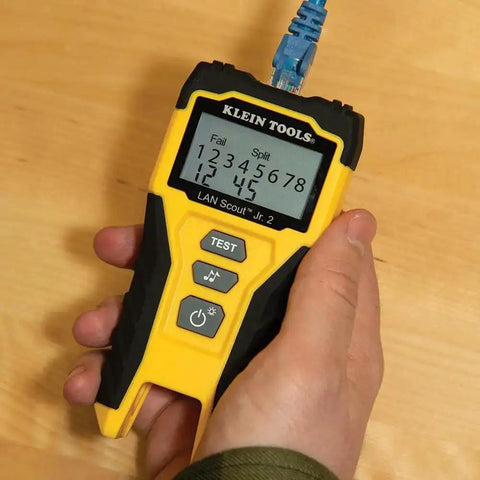 Hand holding yellow LAN Scout Jr 2 Ethernet Cable Tester For CAT5e CAT6 CAT6A RJ45 Cables With Backlit LCD Wiremap