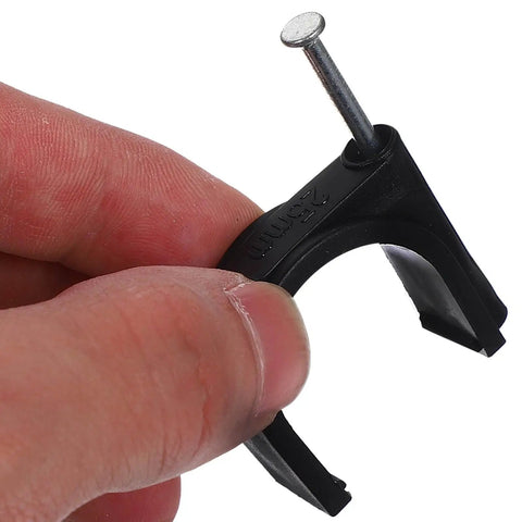 Person holding 100 Pack Black 25mm Plastic Half Clamp Fixtures With Steel Nails For Pipe Support And Cable Clamp Fasteners