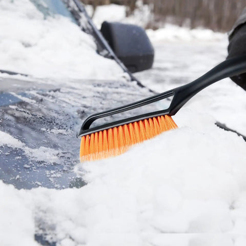 27 Inch Snow Brush With Detachable Ice Scraper And Ergonomic Foam Grip For Cars Trucks And SUVs Heavy Duty ABS PVC Bristle Brush Orange in use on a snow-covered car.