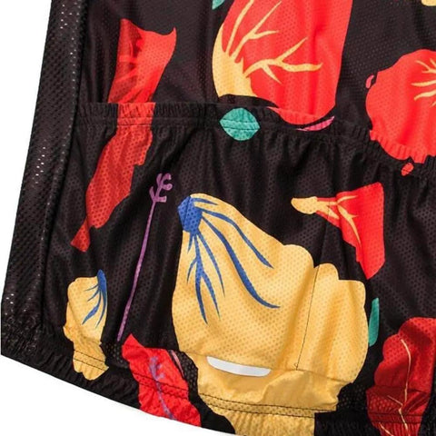 Multicolored floral print fabric with black mesh background, close-up view highlighting vibrant red, yellow, and blue patterns.