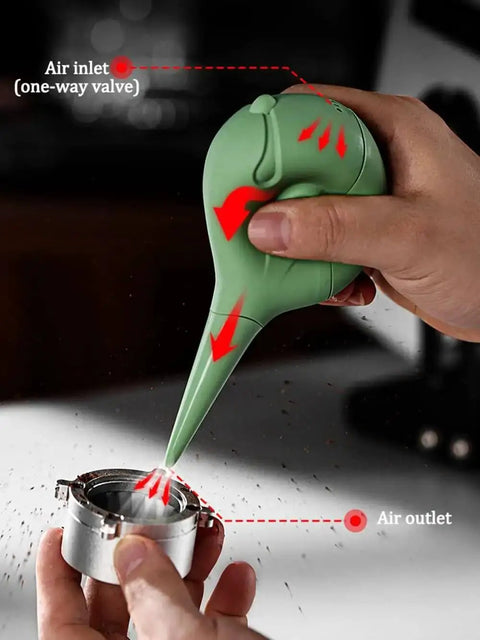 Green Dope Bird Inspired Coffee Air Blower Air Duster for Espresso Machines being used on metal component