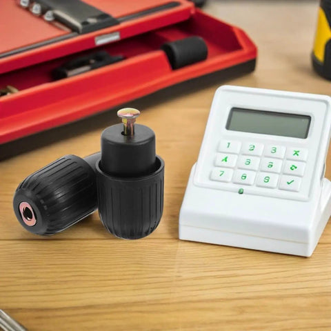 Two Pack Knob Clamping Jig With Spring Mechanism For Computer Chair Swivel Base Tray on a desk, near a keypad device